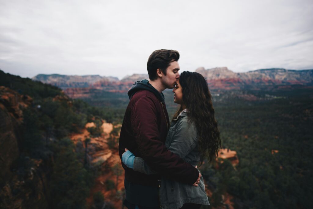 Couples embracing with a mountain background